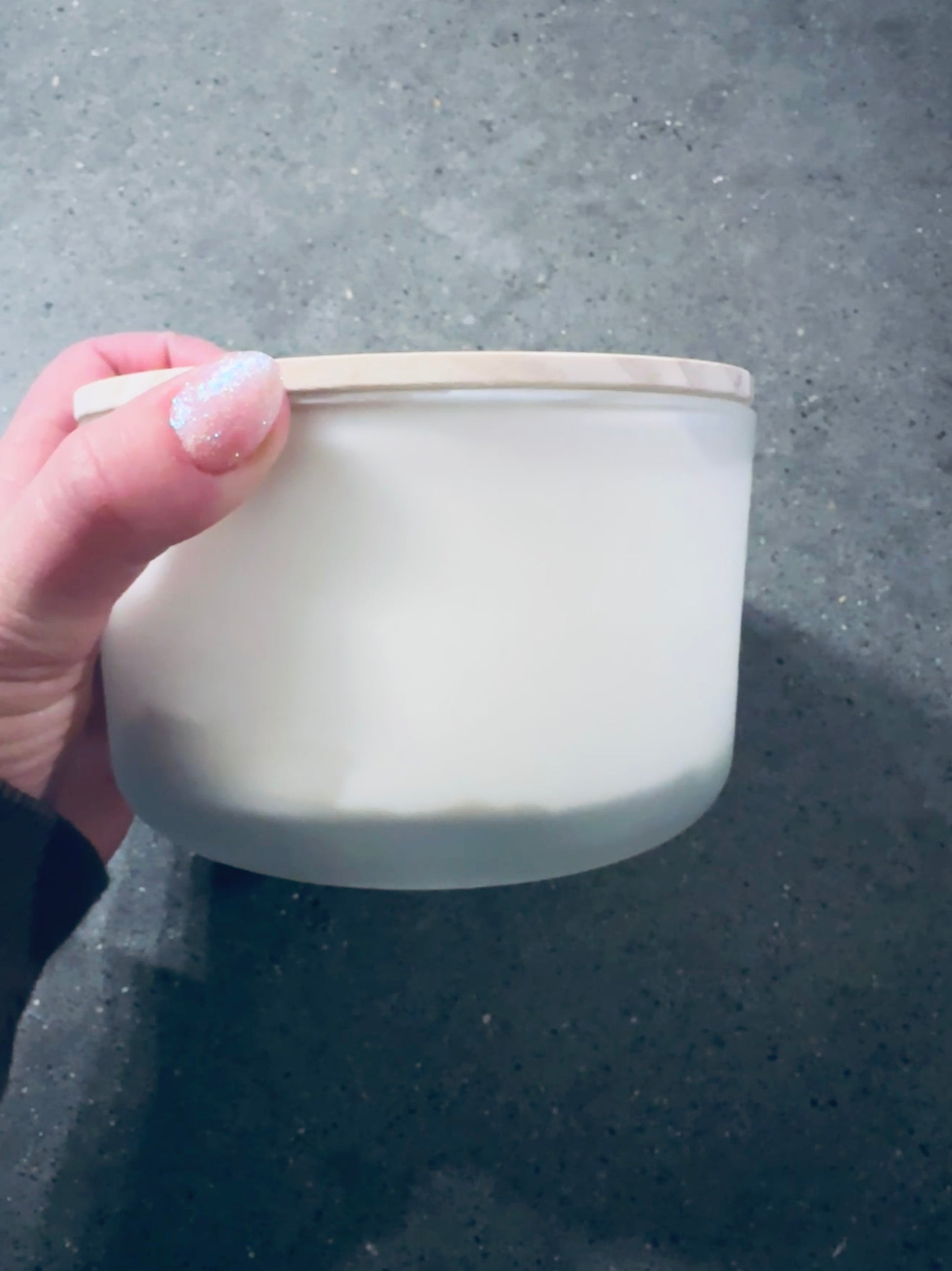 a person holding a container with a white substance in it