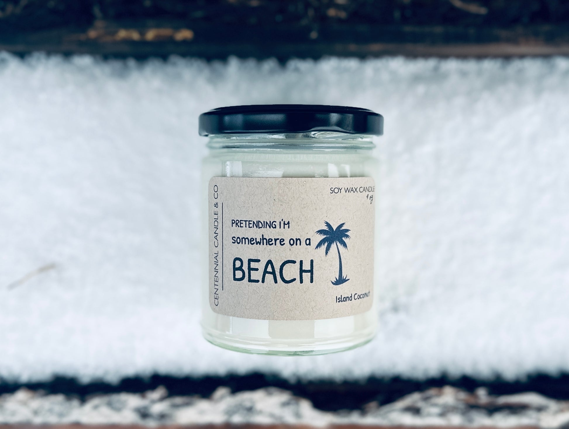 a jar of white sand sitting on top of a white rug