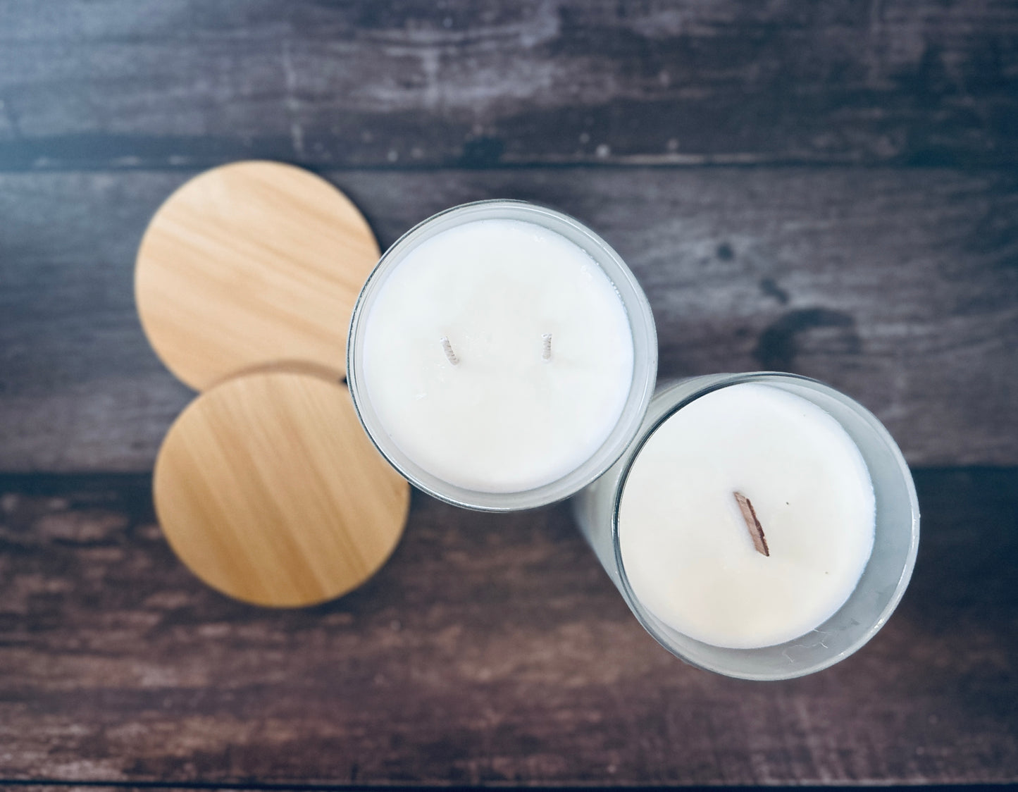 two candles sitting on top of a wooden table