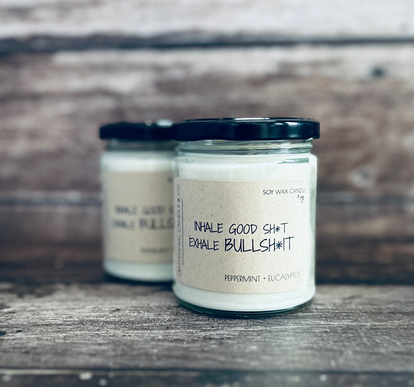 two candles sitting on top of a wooden table