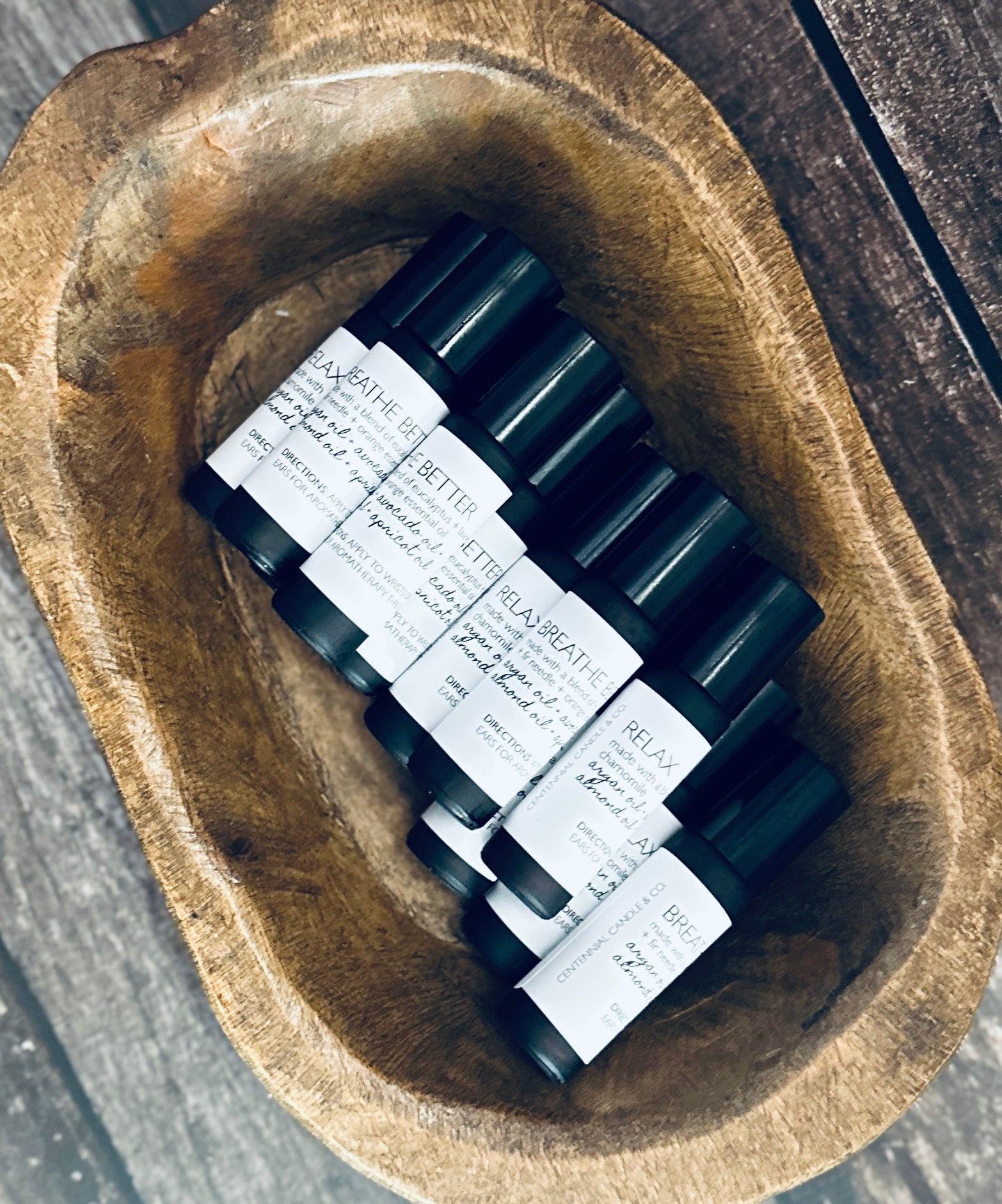 a wooden bowl filled with black and white labels