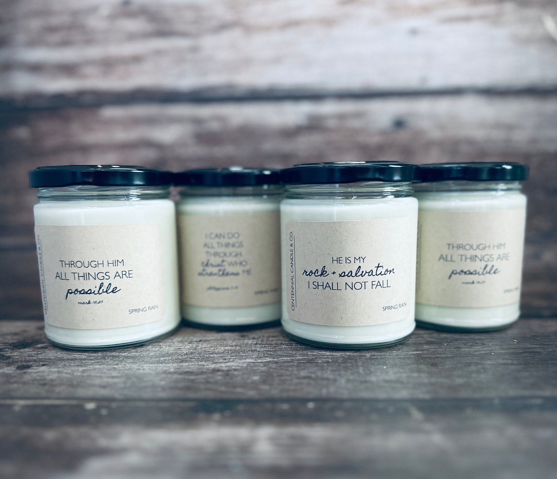 three jars of candles sitting on top of a wooden table