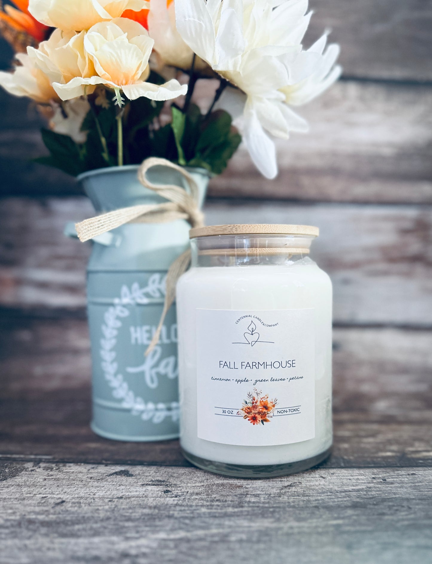 a jar of flowers sitting next to a vase of flowers