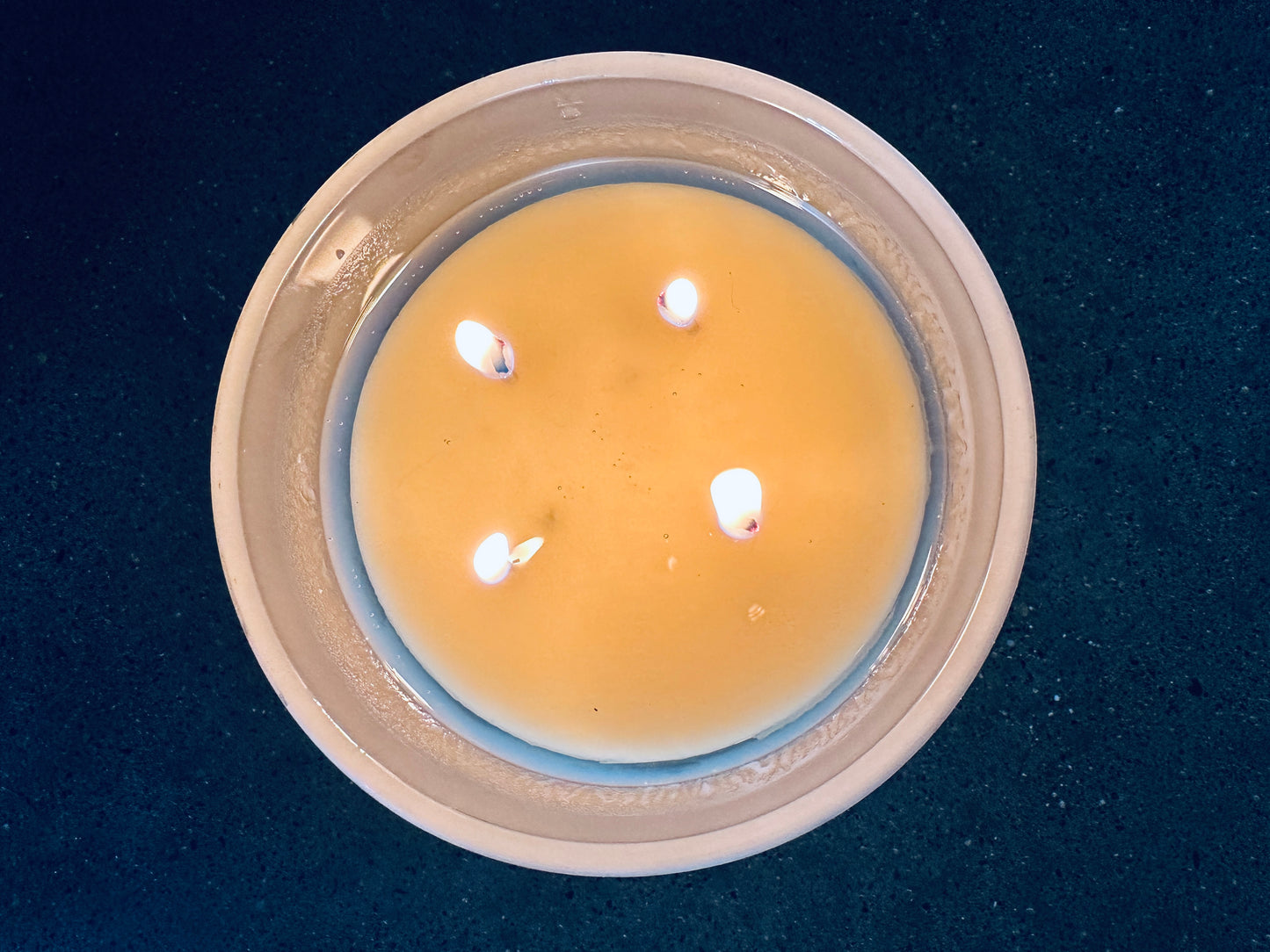 a glass bowl filled with water and lit candles